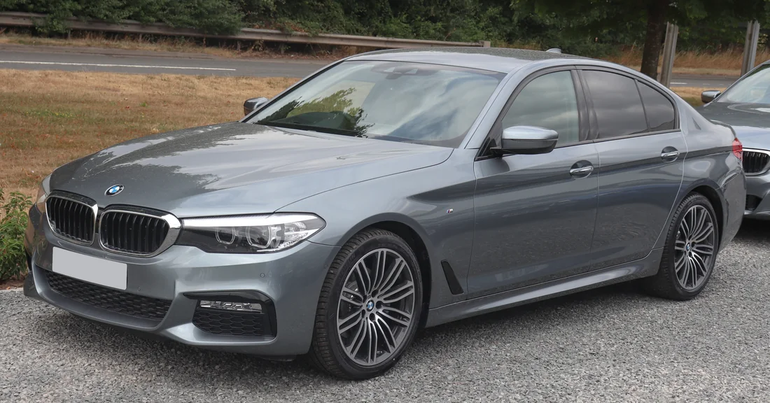Grey BMW 5 Series sedan photographed from the front and side.